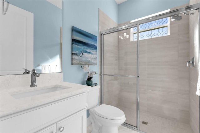 bathroom with vanity, an enclosed shower, and toilet