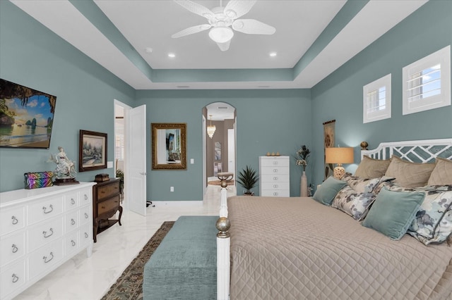 bedroom featuring ceiling fan and a tray ceiling