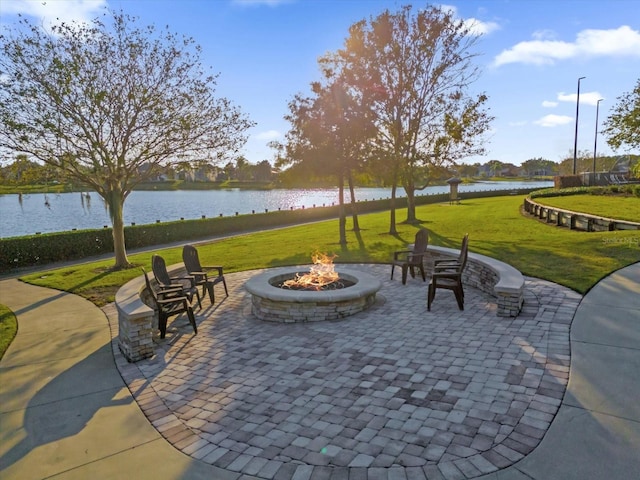 view of patio with a water view and an outdoor fire pit