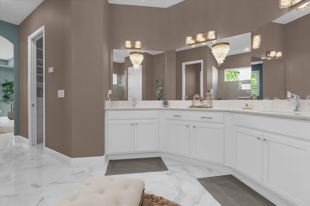 bathroom featuring vanity and a chandelier