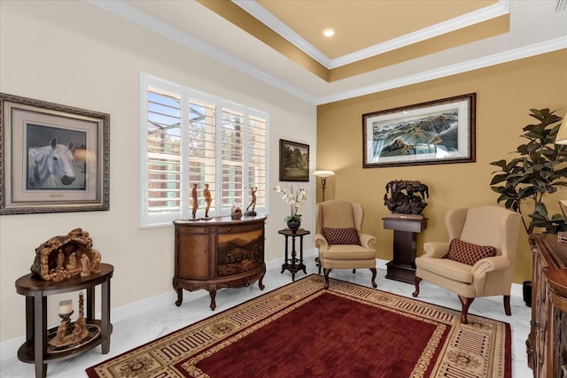 sitting room with ornamental molding and a tray ceiling