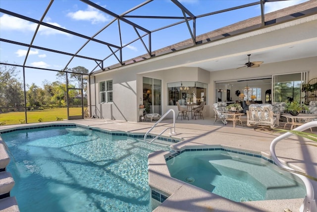 view of swimming pool featuring ceiling fan, a lanai, an in ground hot tub, and a patio