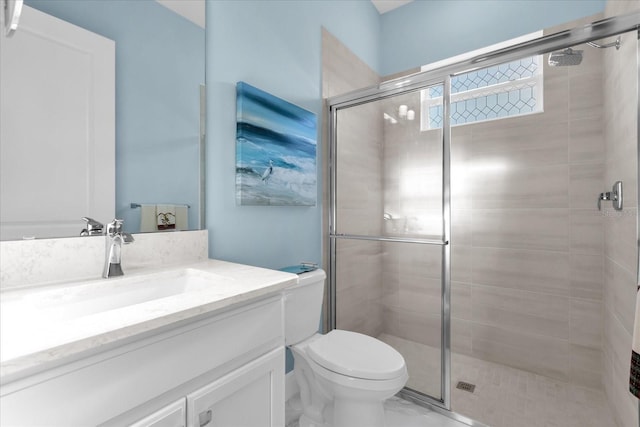 bathroom featuring an enclosed shower, vanity, and toilet