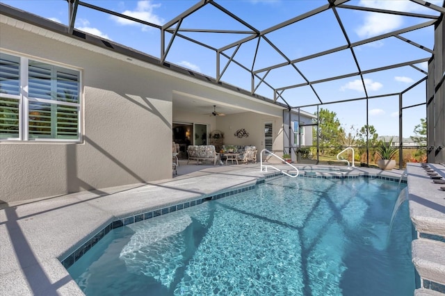 view of swimming pool featuring pool water feature, ceiling fan, a lanai, and a patio