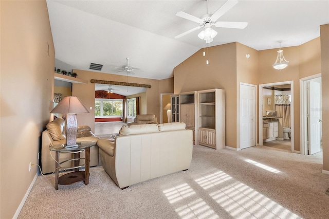 living room with light colored carpet, high vaulted ceiling, and ceiling fan