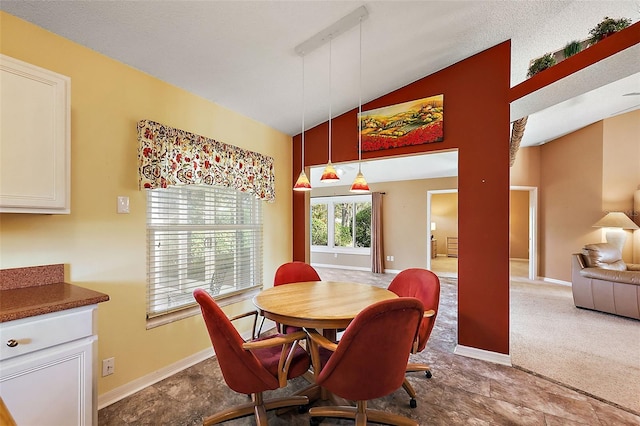 dining area featuring a textured ceiling, lofted ceiling, and carpet floors