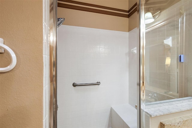 bathroom featuring a shower with door