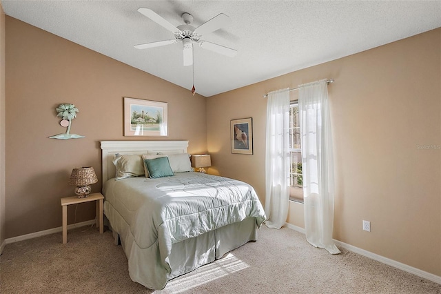 carpeted bedroom with ceiling fan, a textured ceiling, and vaulted ceiling