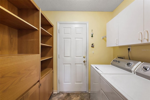 laundry room featuring cabinets, a textured ceiling, and separate washer and dryer