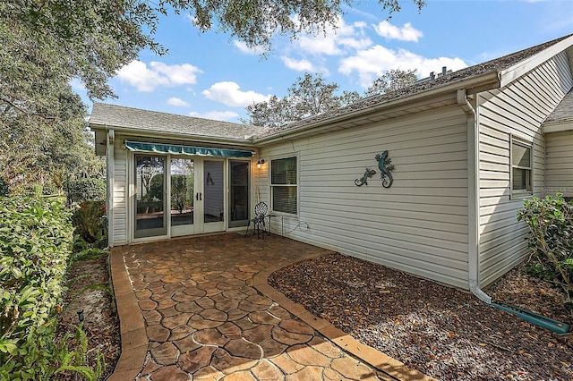 rear view of house with a patio area and french doors