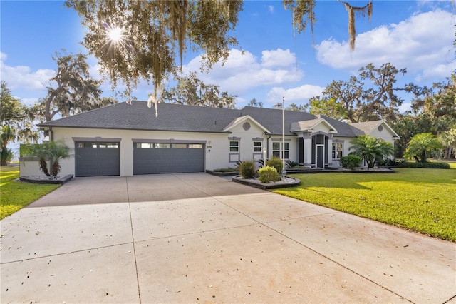 view of front of property featuring a front yard and a garage