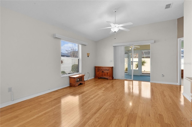 spare room with ceiling fan, plenty of natural light, vaulted ceiling, and light wood-type flooring