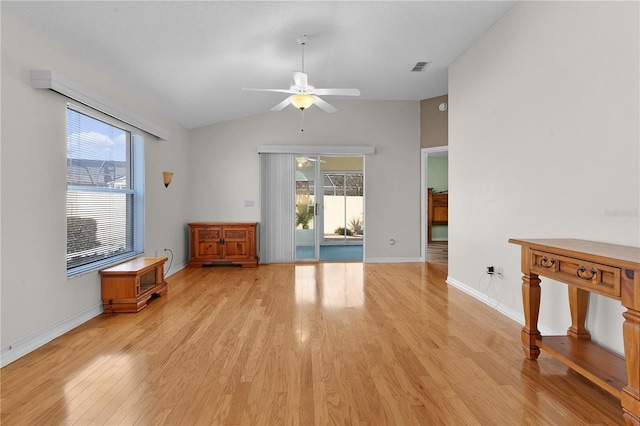 interior space with light hardwood / wood-style floors, ceiling fan, and lofted ceiling