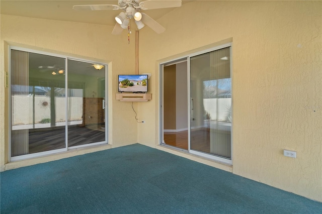 exterior space featuring ceiling fan