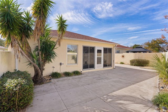 rear view of property featuring a patio