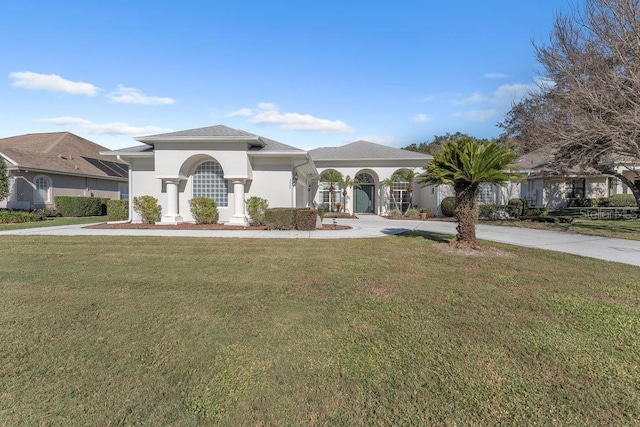 mediterranean / spanish-style house with a front lawn