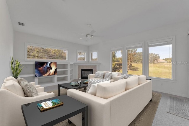 carpeted living room with ceiling fan