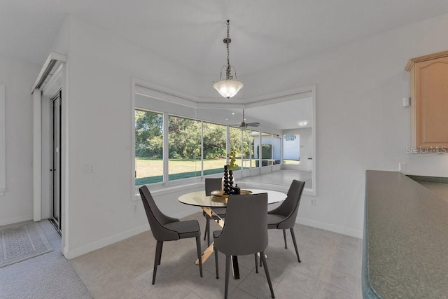 dining space with ceiling fan and light tile patterned flooring