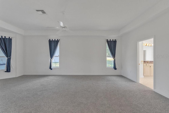 carpeted spare room with ceiling fan