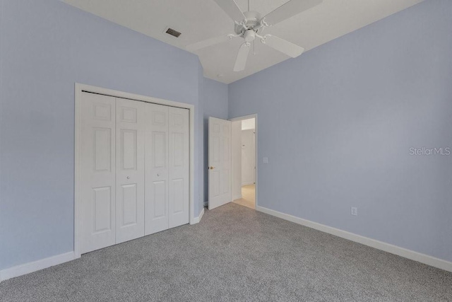 unfurnished bedroom with ceiling fan, a closet, and light carpet