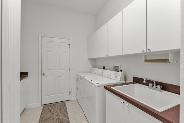 laundry room featuring washer and dryer, sink, light tile patterned floors, and cabinets