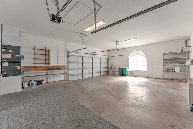 garage featuring heating unit and a garage door opener