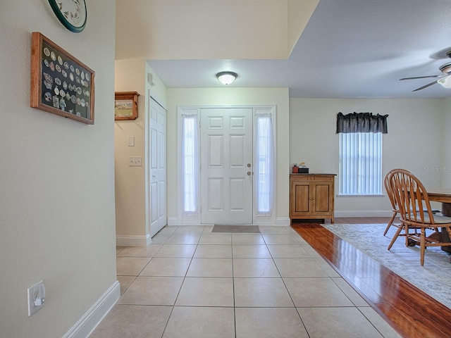 foyer entrance with ceiling fan, light hardwood / wood-style flooring, and a healthy amount of sunlight