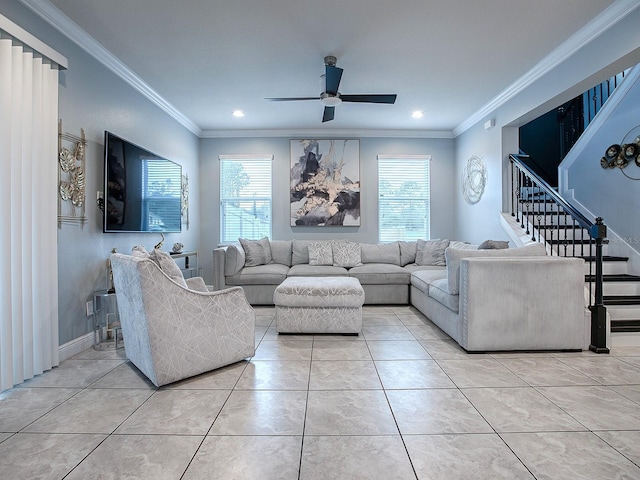 living room with ceiling fan, light tile patterned flooring, a healthy amount of sunlight, and ornamental molding