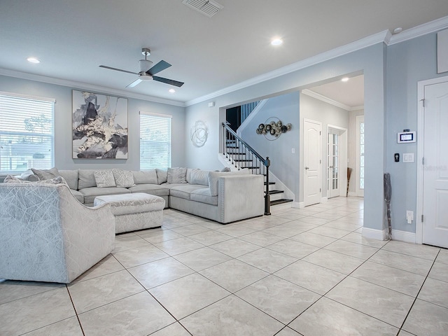 tiled living room with a healthy amount of sunlight, ceiling fan, and ornamental molding