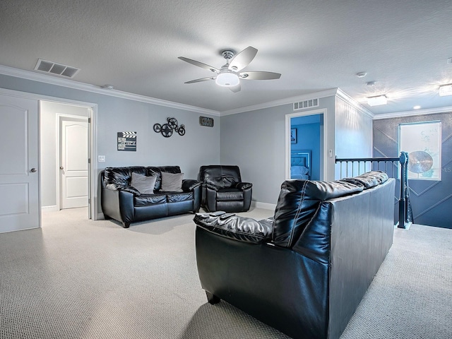 living room with ceiling fan, light colored carpet, ornamental molding, and a textured ceiling