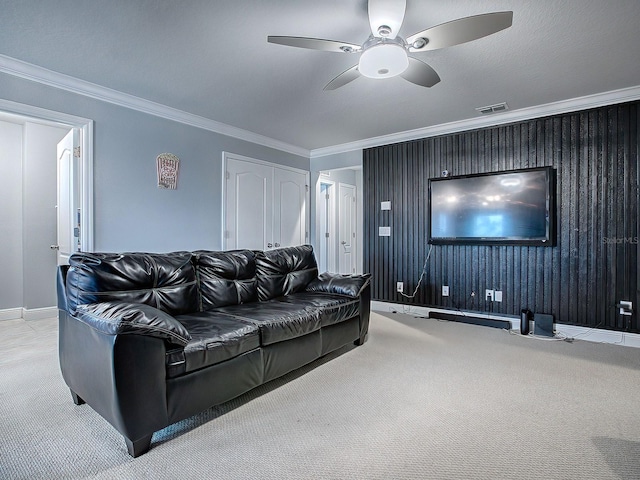 living room with crown molding, ceiling fan, and light carpet