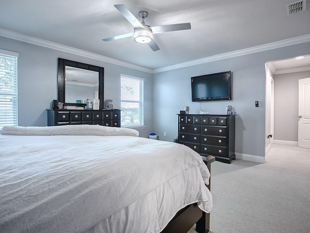 bedroom featuring ceiling fan, crown molding, and light carpet