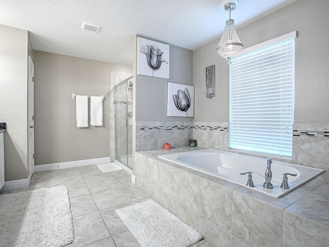 bathroom featuring tile patterned floors, plus walk in shower, and a textured ceiling