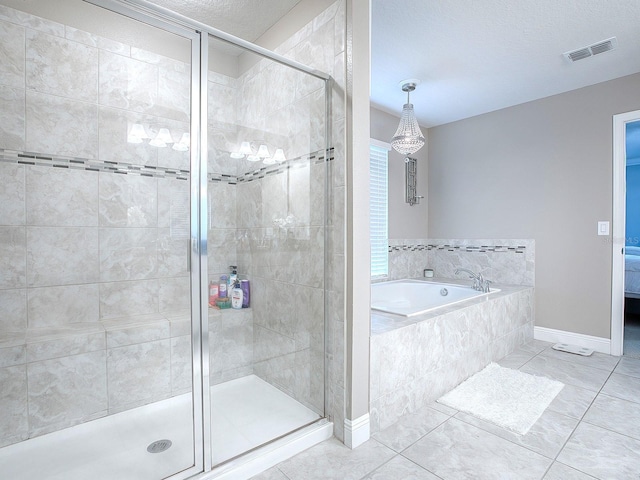 bathroom with tile patterned floors, a textured ceiling, and shower with separate bathtub