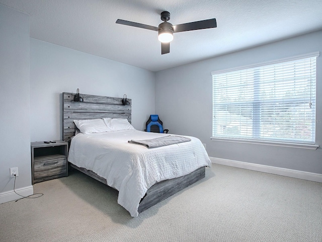 bedroom featuring ceiling fan and carpet