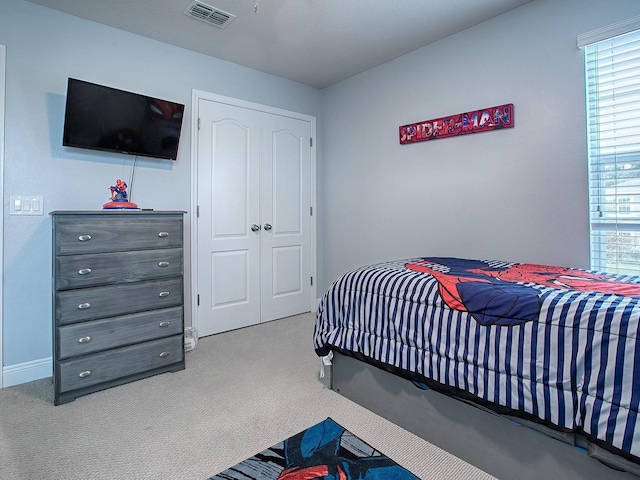 carpeted bedroom featuring a closet