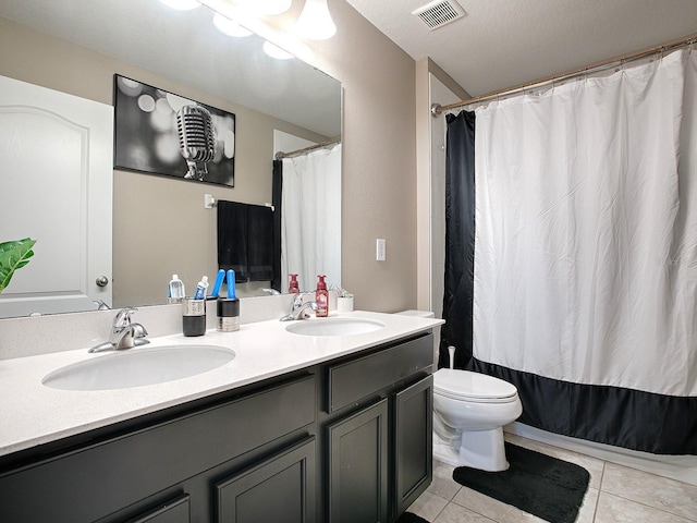 bathroom featuring vanity, tile patterned floors, a shower with curtain, toilet, and a textured ceiling