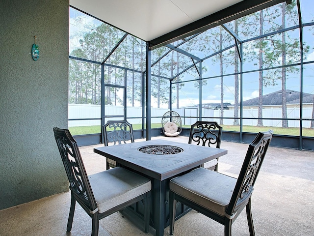 view of patio / terrace featuring a water view and glass enclosure