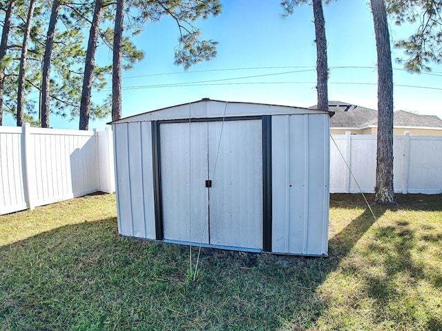 view of outbuilding featuring a lawn