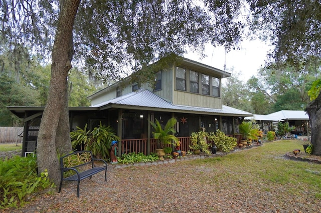 view of front facade with a sunroom and a front lawn