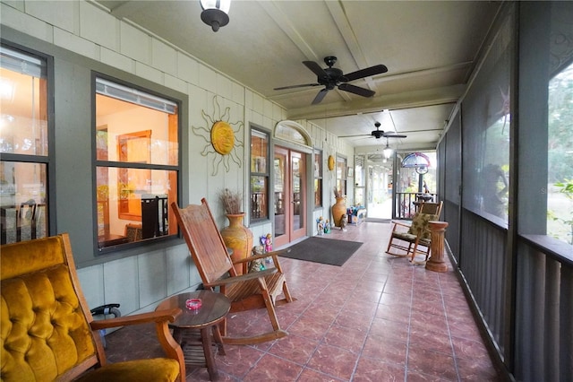 sunroom featuring ceiling fan