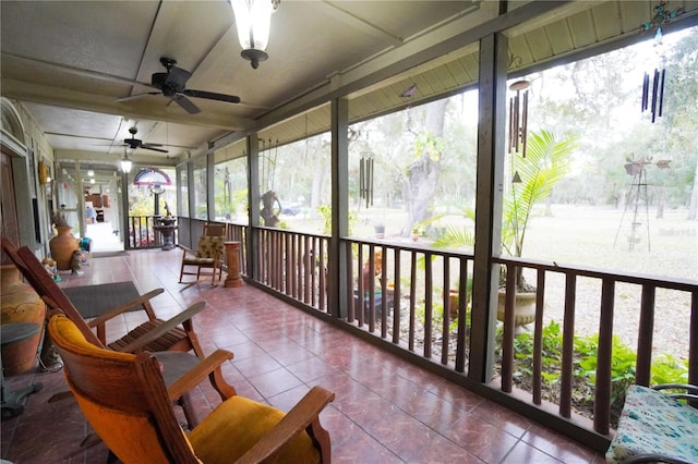 sunroom featuring ceiling fan