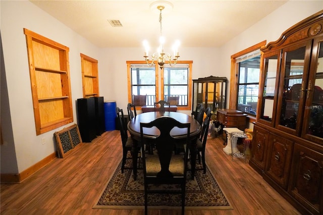 dining room with a notable chandelier and dark hardwood / wood-style flooring