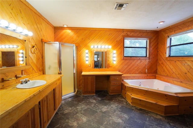 bathroom featuring ornamental molding, wooden walls, independent shower and bath, and vanity