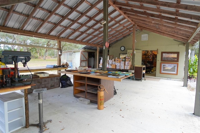 exterior space featuring a workshop area and high vaulted ceiling