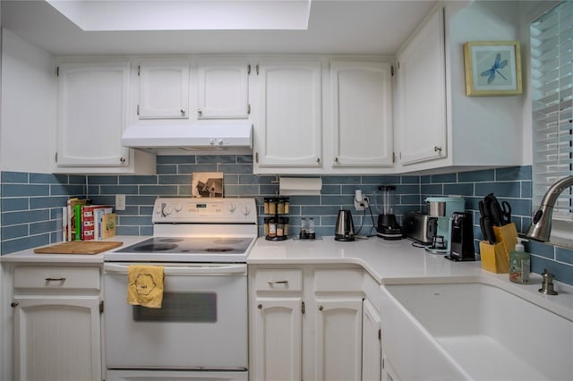 kitchen featuring white electric range oven, decorative backsplash, white cabinetry, and sink