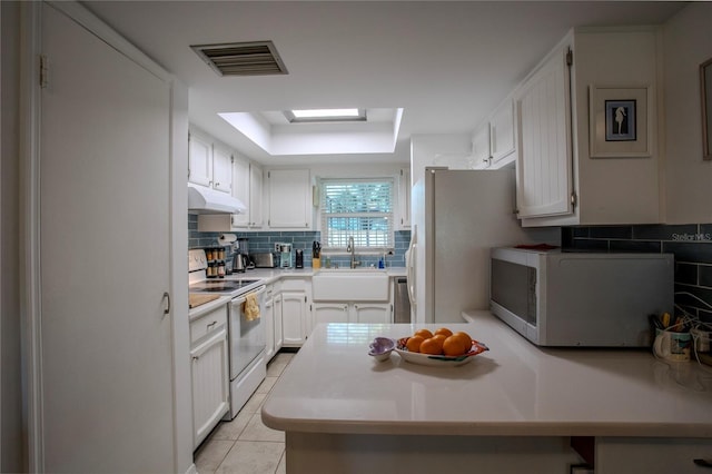 kitchen with white cabinetry, white appliances, sink, and light tile patterned floors