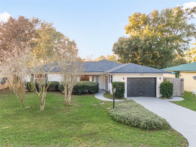 ranch-style house with a front yard and a garage