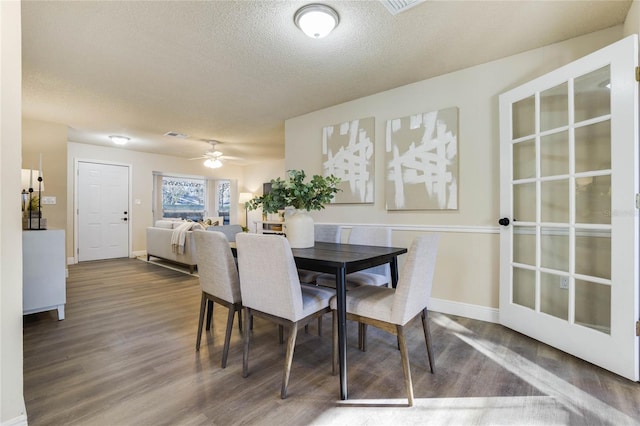 dining space with a textured ceiling, hardwood / wood-style flooring, and ceiling fan