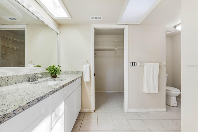 bathroom with tile patterned floors, vanity, and toilet